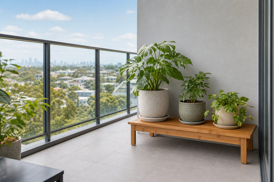 Low wooden plant stand with potted plants in a sheltered apartment balcony corner