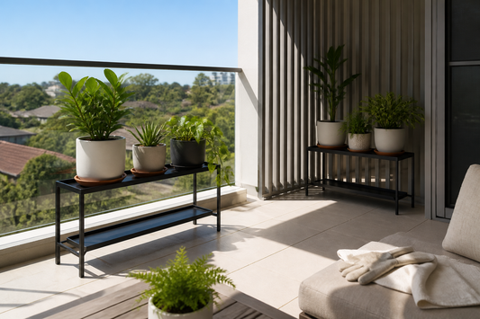 Metal plant stands with potted plants in sun and shade on an Australian apartment balcony