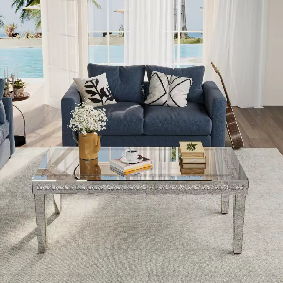 Rectangular mirrored coffee table with crystal diamond inlay in a bright living room setup.