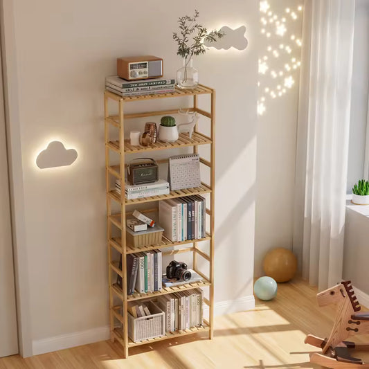 Tall 6-tier bamboo bookshelf styled with decor, books, a radio, and a camera in a sunlit room.