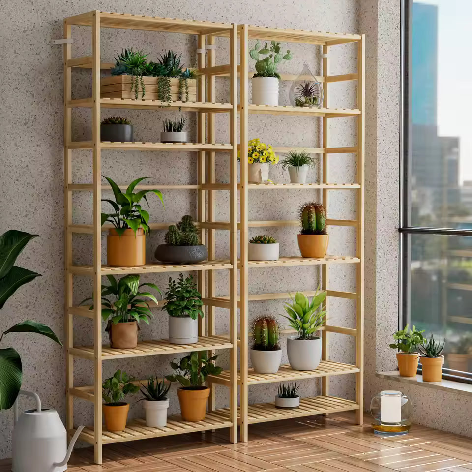 Tall light wood shelving unit with multiple shelves holding potted plants and cacti next to a window.