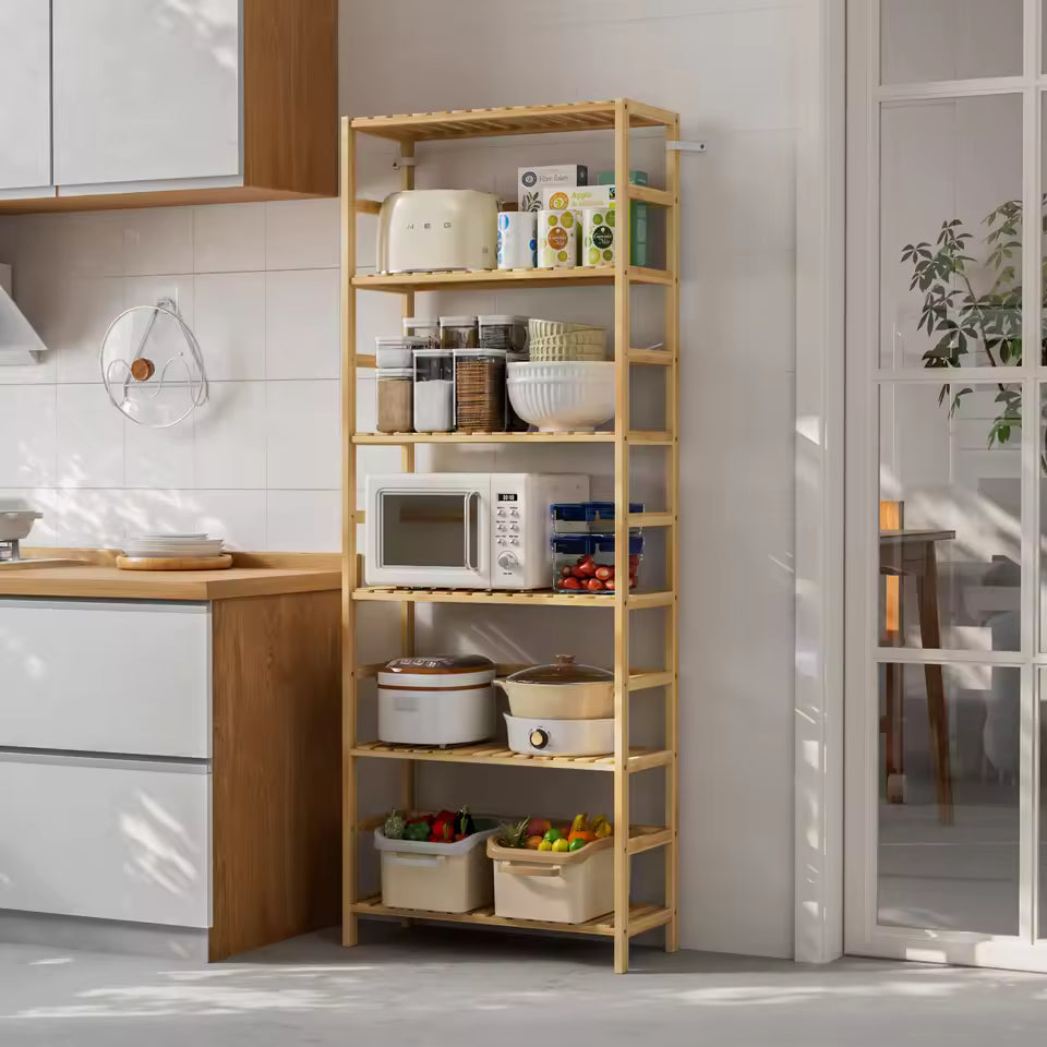 Tall bamboo kitchen shelving rack holding small appliances, jars, cookware, and storage bins.