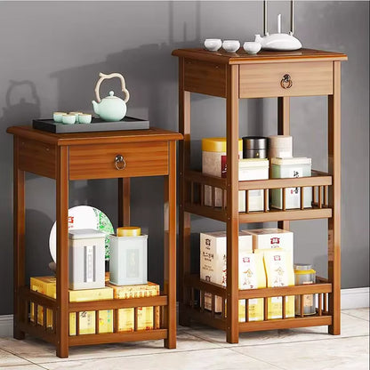 Two bamboo storage end tables with drawers and open shelves displaying tea sets and containers.