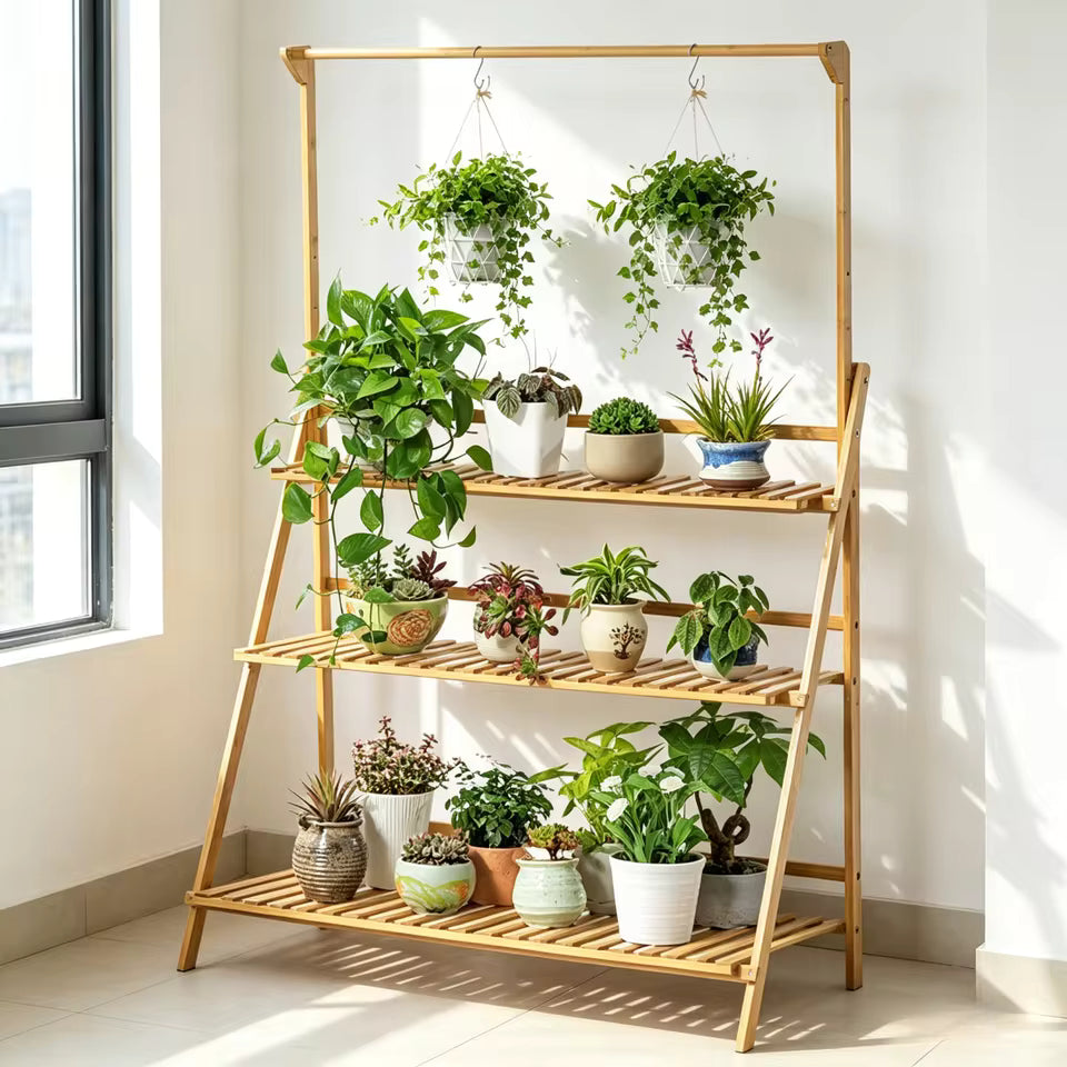 3-tier bamboo plant stand with a top hanging bar holding various potted houseplants indoors.