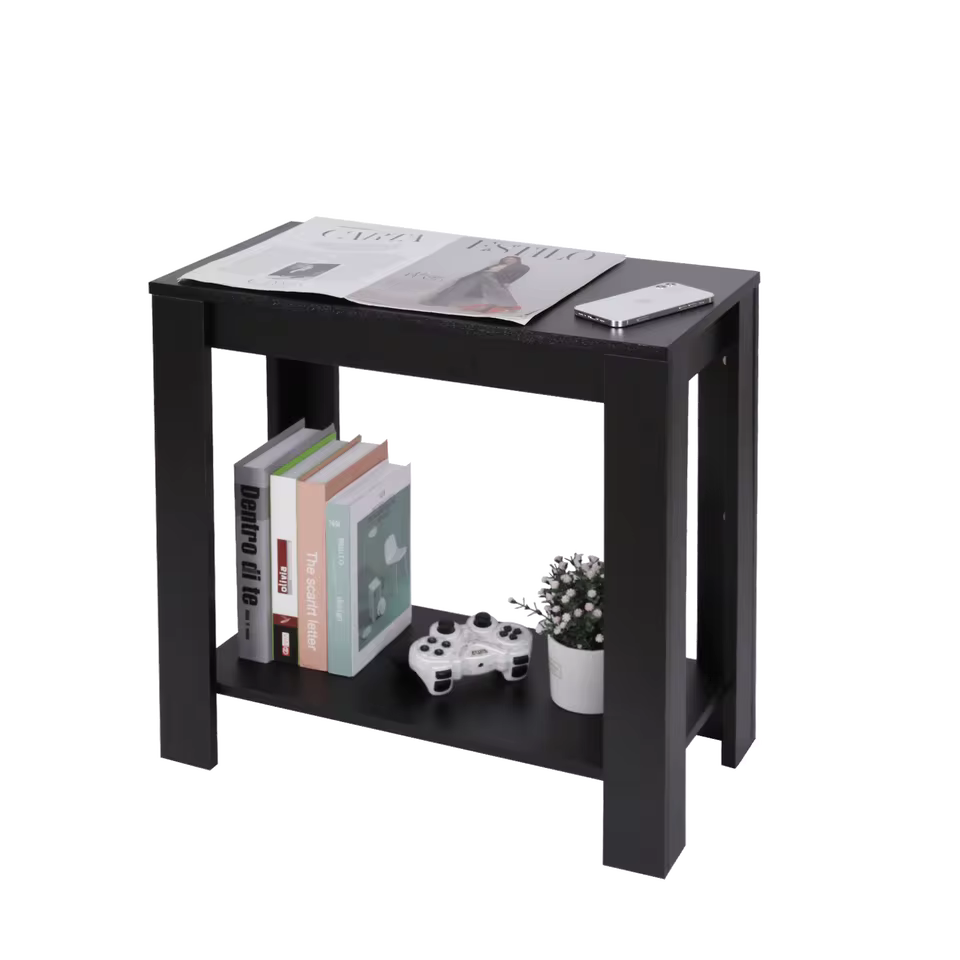 Modern black narrow side table featuring two open storage tiers holding books, a controller, and a small plant.