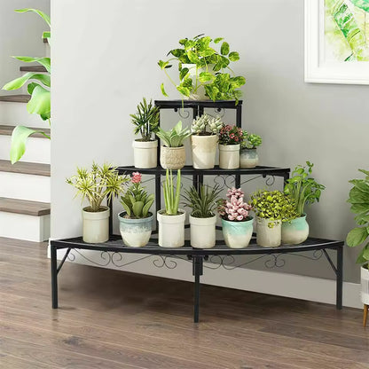 Black 3-tier metal quarter-round corner plant stand holding various potted plants indoors.
