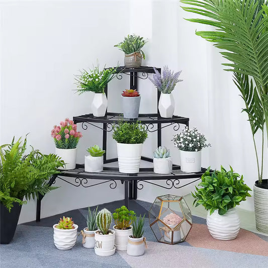 3-tier black metal quarter-round corner plant stand holding various potted plants and succulents.