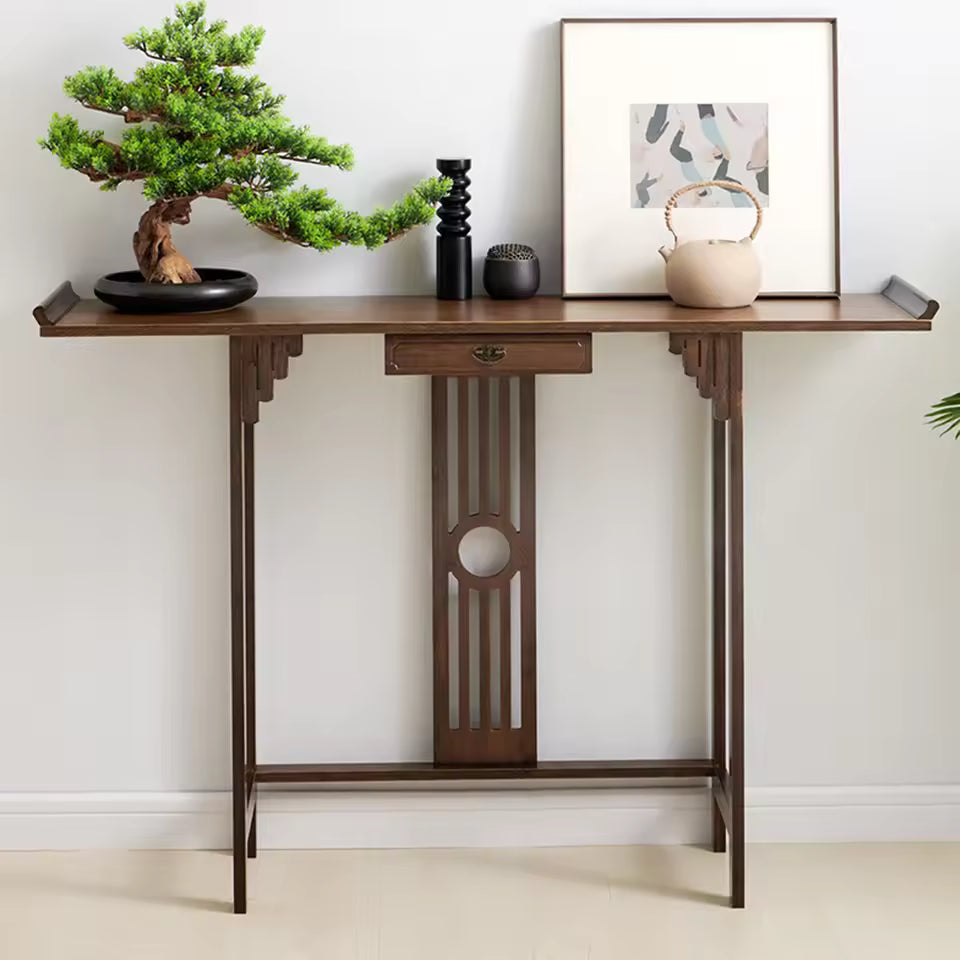 Chinese-style dark wood entryway console table decorated with a bonsai tree, teapot, and framed art.