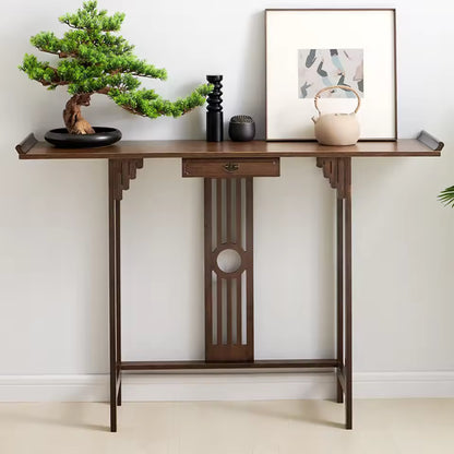 Chinese-style dark wood entryway console table decorated with a bonsai tree, teapot, and framed art.