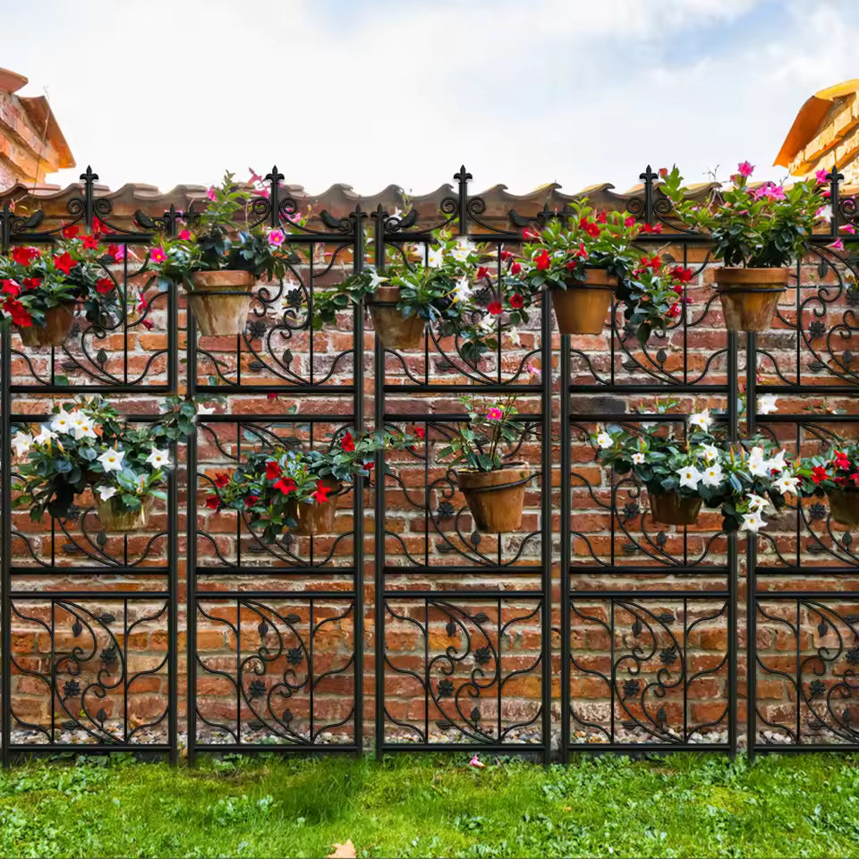 Decorative black metal lattice trellis panels holding potted flowering plants against a brick wall.