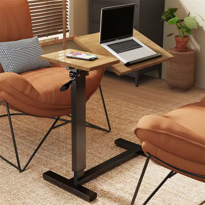 Adjustable wooden C-shaped side table with a laptop tilt section positioned between two armchair chairs.