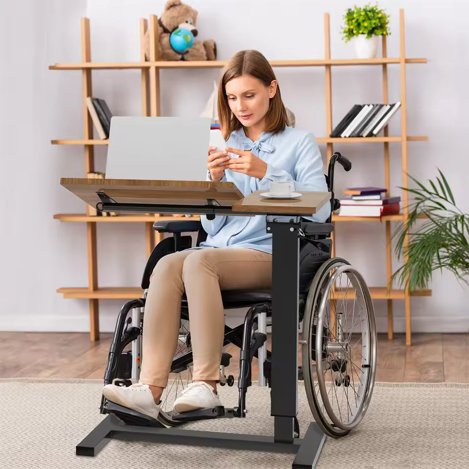 Woman in a wheelchair using a mobile adjustable rolling desk with a laptop and coffee cup.