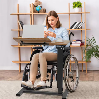 Woman in a wheelchair using a mobile adjustable rolling desk with a laptop and coffee cup.