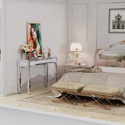 Silver mirrored console table with crushed diamond trim set in an elegant bedroom decor.