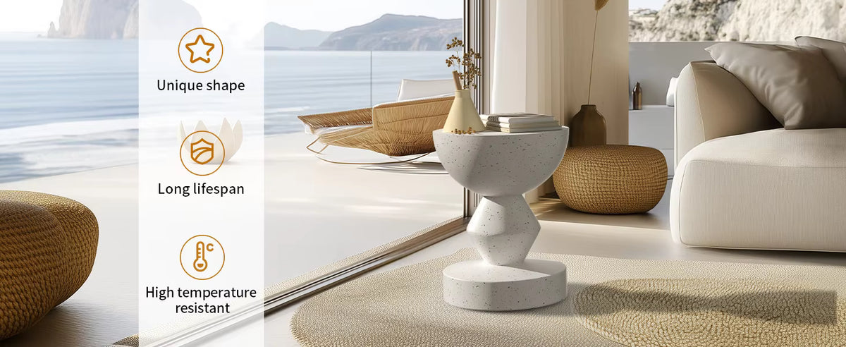 Modern speckled concrete accent side table with a geometric, sculptural base placed near a window.