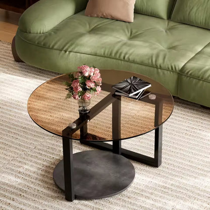 Round coffee table featuring an amber-tinted tempered glass top, a lower sintered stone shelf, and a black metal frame.