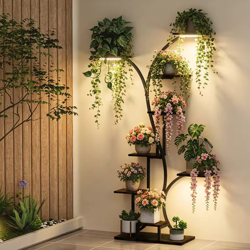 Curved black metal plant stand with grow lights displaying various potted plants and flowers.
