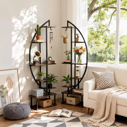 Two half-moon plant stands filled with plants and decor next to a white sofa in a living room.
