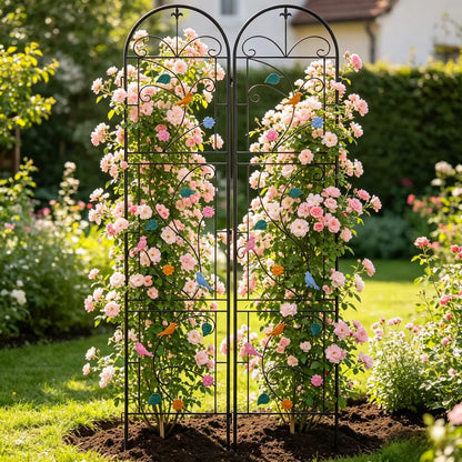 Two-panel black metal garden trellis decorated with colorful birds and leaves, supporting pink roses.