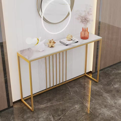 White marbled console table with a gold metal frame, decorated with books, ornaments, and a vase.
