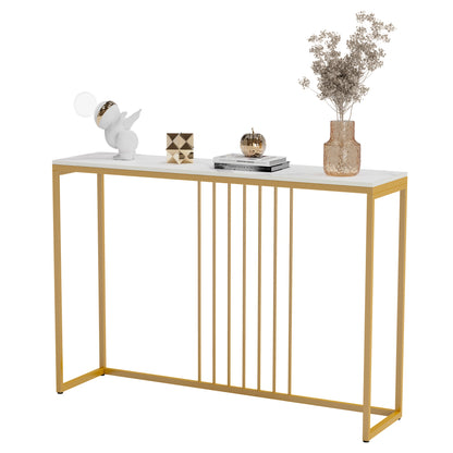 White marble-top console table with gold metal legs, styled with decorative objects and a vase.