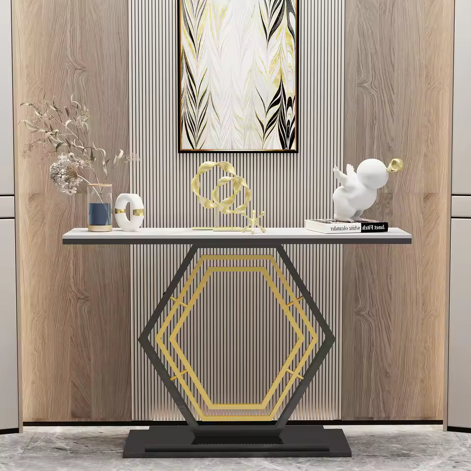 Modern console table with a geometric black and gold base and decorative objects on top.