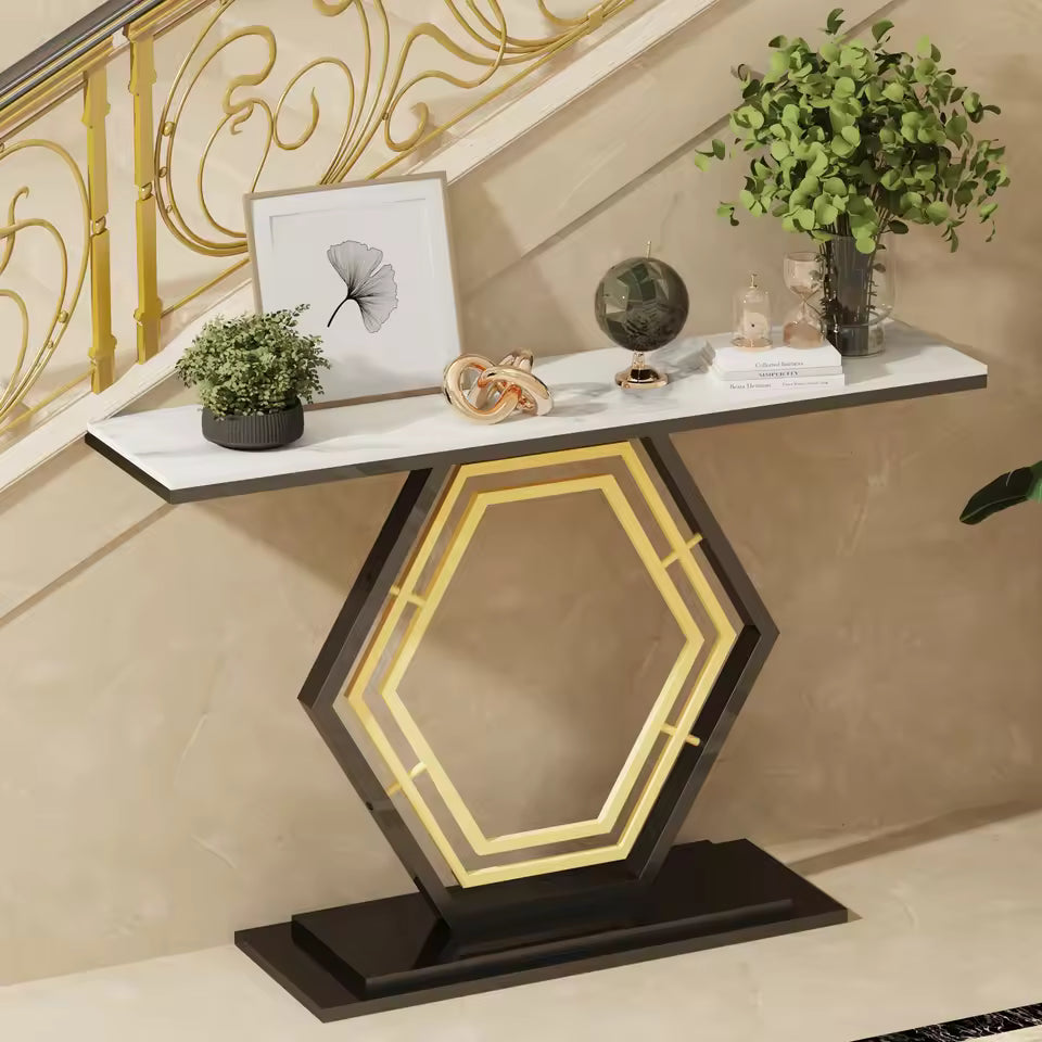 White sintered stone console table with a geometric hexagonal base, plants, and decorative objects.