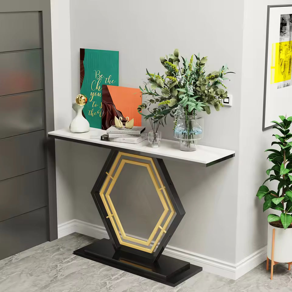 Modern narrow console table with a white top and geometric base, styled with artwork and foliage.