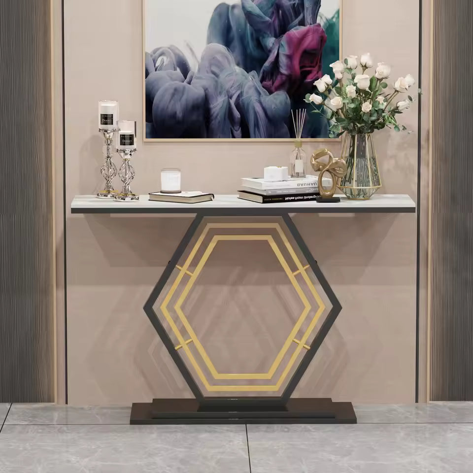 Modern console table with white stone top and geometric black and gold hexagonal base.