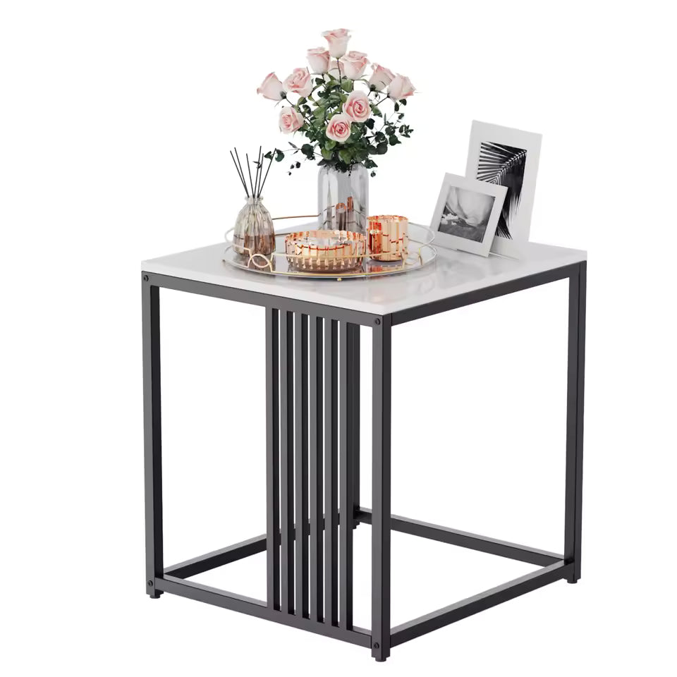 White marble-top end table with a black metal frame, styled with pink roses and picture frames.