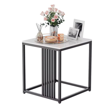 White marble-top end table with a black metal frame, styled with pink roses and picture frames.