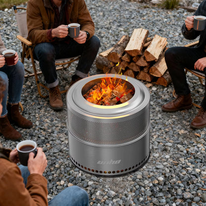 Stainless steel cylindrical smokeless fire pit burning outdoors, surrounded by people sitting with mugs.