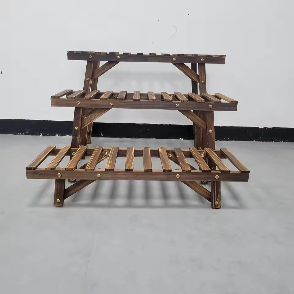 3-tier dark wood stepped plant stand display rack with slatted shelves against a plain wall.